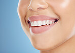 Teeth, smile and mouth of a woman for dental care isolated on a blue background in studio. Healthcare, happy and model showing the results of a tooth whitening treatment and promotion of oral hygiene