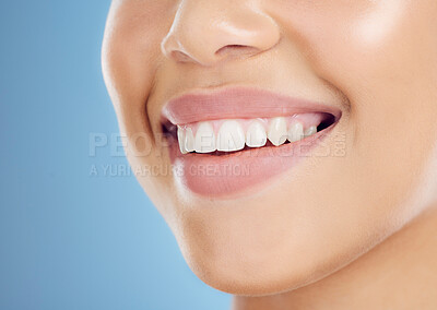 Buy stock photo Teeth, smile and mouth of a woman for dental care isolated on a blue background in studio. Healthcare, happy and model showing the results of a tooth whitening treatment and promotion of oral hygiene