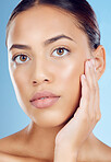 Face, woman and cosmetics skincare in studio for beauty, wellness and laser glow results from salon spa. Model portrait, facial aesthetic and dermatology on blue background for natural healthy shine 