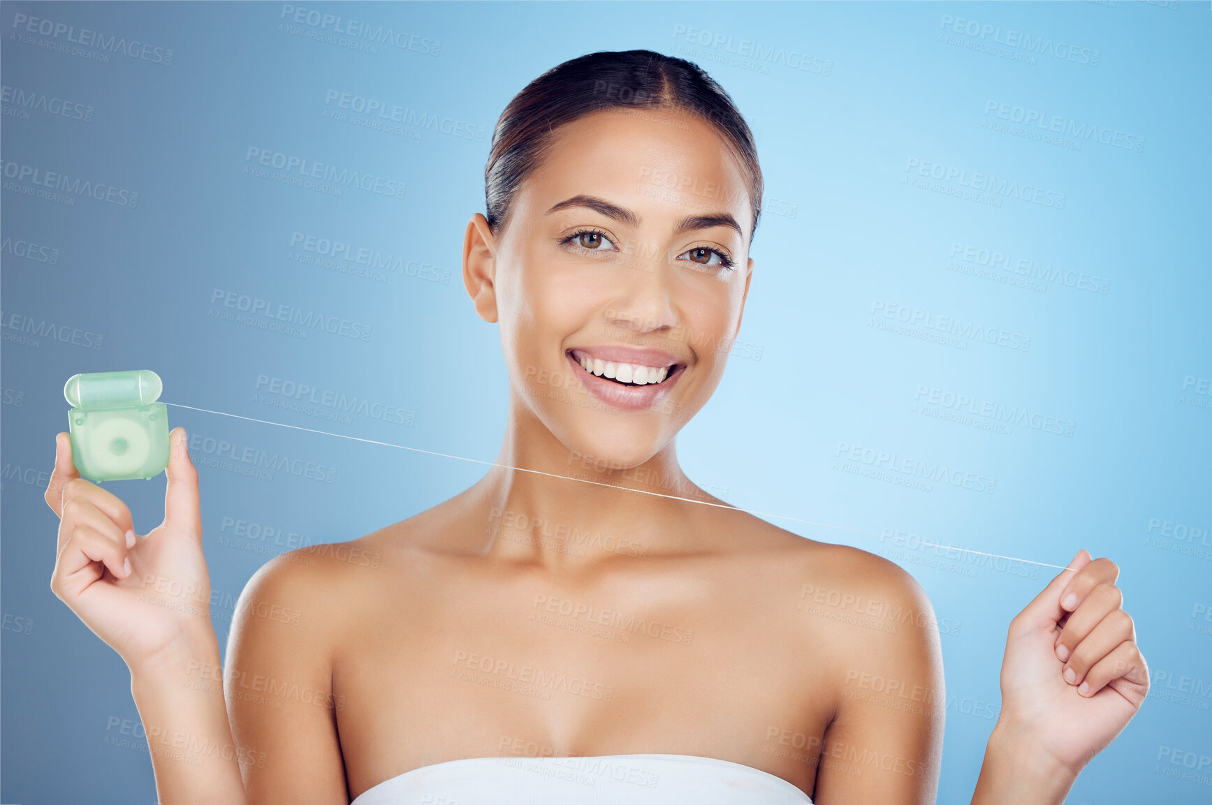 Buy stock photo Floss product, dental portrait and woman on studio mockup for teeth, mouth cleaning and marketing. Happy female model, flossing thread and blue background for tooth cosmetics, wellness and healthcare