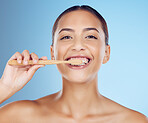 Teeth, woman and portrait of bamboo toothbrush for dental wellness, healthy cleaning or beauty cosmetics. Happy female, eco wooden brush and toothpaste of mouth, face smile and studio blue background