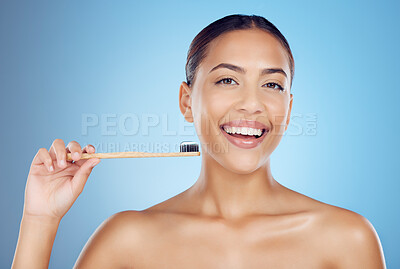 Buy stock photo Brushing teeth, woman and portrait of bamboo toothbrush for dental healthcare, breath and cleaning cosmetics. Happy female, eco wooden brush and toothpaste for mouth, smile and studio blue background