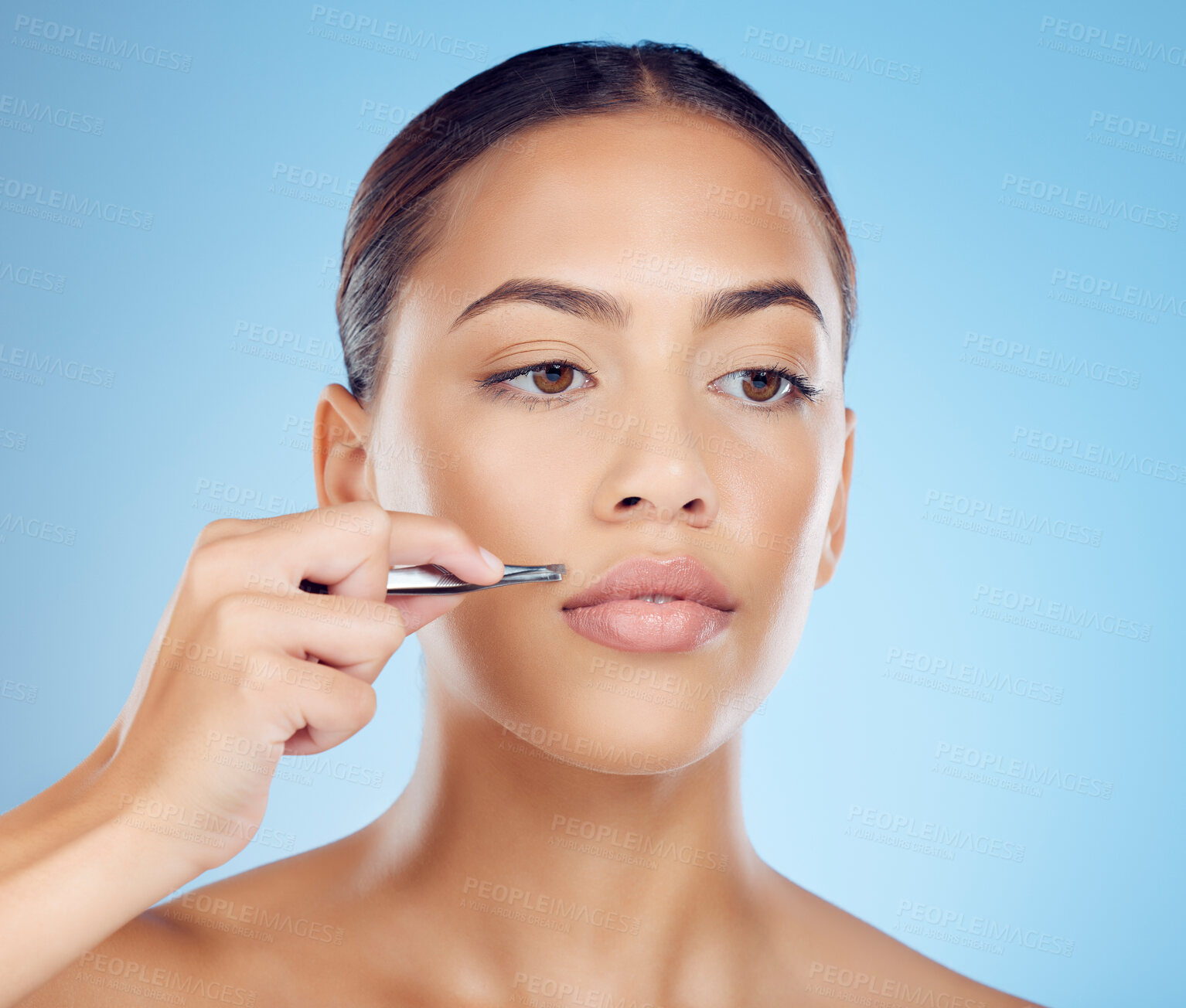 Buy stock photo Tweezer, lip and hair removal with woman in studio for beauty, grooming and hygiene on blue background. Facial, moustache and product or tool for girl model with mouth, hairs and cleaning isolated