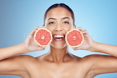 Buy stock photo Grapefruit, woman and smile for beauty portrait on studio background for wellness benefits. Skincare model, diet and citrus fruits for natural detox, healthy nutrition and happy face with vitamin c