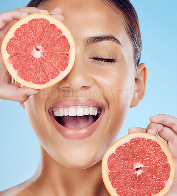 Buy stock photo Grapefruit, laughing and woman with face for beauty on studio background, wellness benefits and smile. Happy model, diet and citrus fruits for natural detox, healthy skincare and vitamin c aesthetic