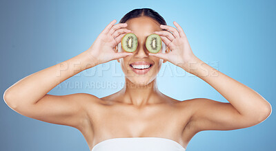 Buy stock photo Kiwi, woman and cover face for skincare, beauty and wellness food on studio background. Happy model, smile and organic green fruits for natural cosmetics, detox and facial nutrition of aesthetic glow