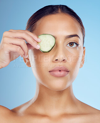 Buy stock photo Cucumber, woman and portrait skincare for face beauty, clean wellness diet and blue studio background. Model, eyes and green fruits cosmetics for detox, facial nutrition or healthy aesthetic benefits