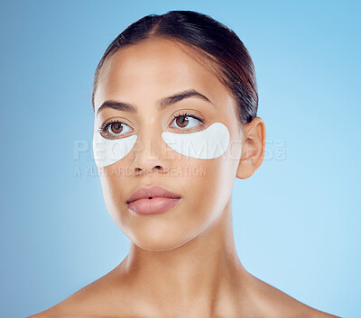 Buy stock photo Black woman with collagen eyes mask isolated on blue background for skincare, beauty and facial cosmetics. Young model or person with dermatology eye patch, anti aging product and skin glow in studio