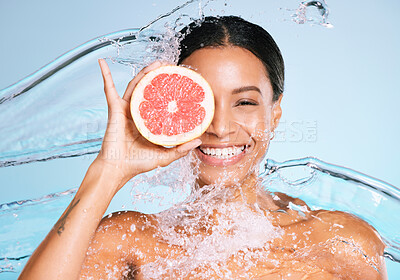 Buy stock photo Beauty, skin care and woman portrait with a grapefruit for healthy skin and diet on blue background. Face of aesthetic model person water splash and fruit for sustainable facial health and wellness