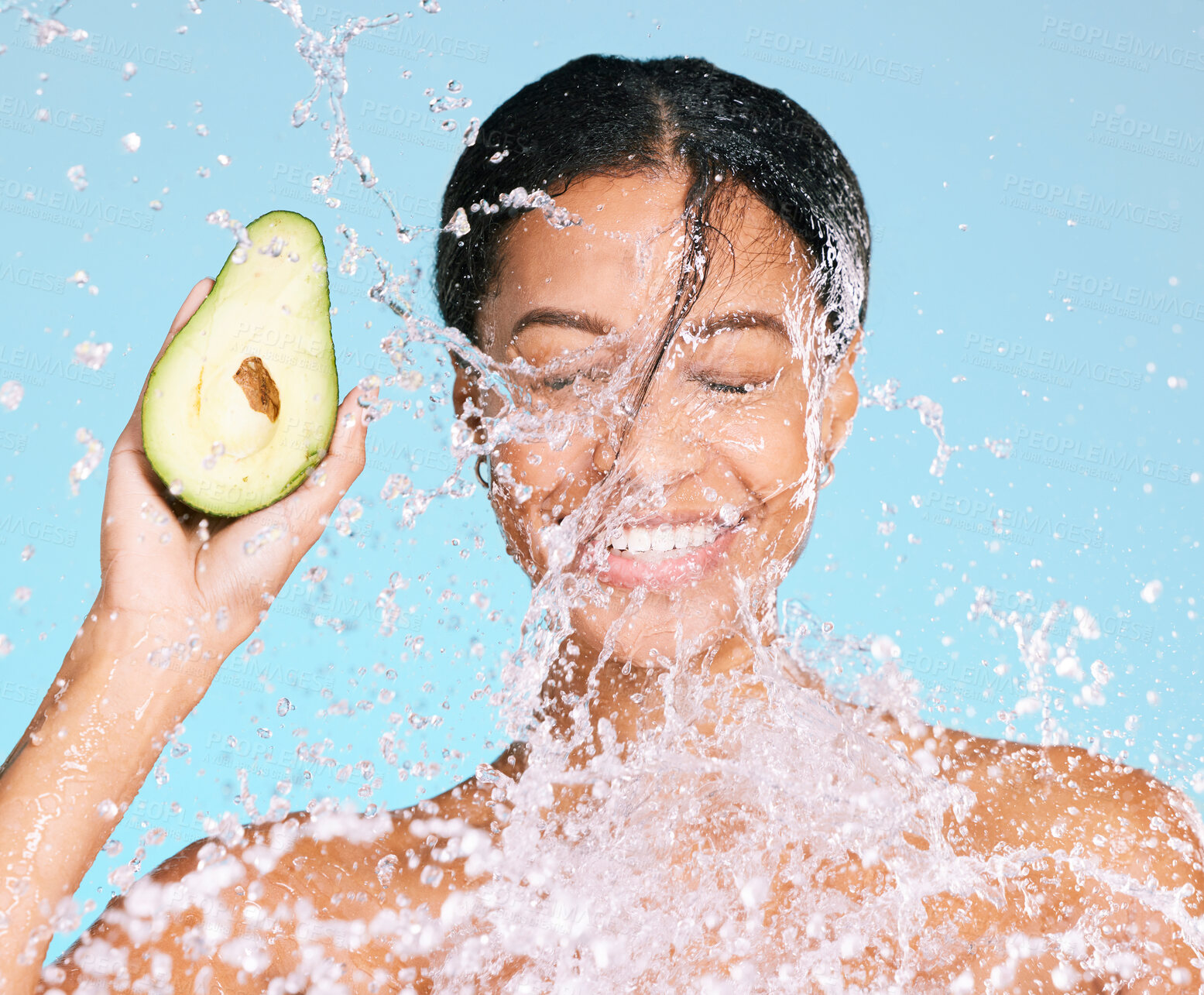 Buy stock photo Beauty, water splash and woman with avocado for healthy skin and diet on a blue background. Face of aesthetic model person with skin care and green food for sustainable facial health and wellness