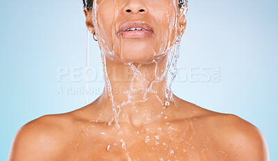 Buy stock photo Face, water and shower with a black woman in studio on a blue background for hygiene or hydration. Splash, cleaning and bathroom with a young female washing her body for natural skincare or wellness