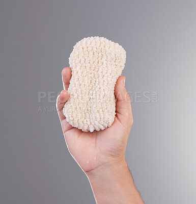 Buy stock photo Shower, grooming and hands with a loofah for hygiene isolated on a grey studio background. Skincare, health and person holding a bathing sponge for washing, cleaning and treatment on a backdrop