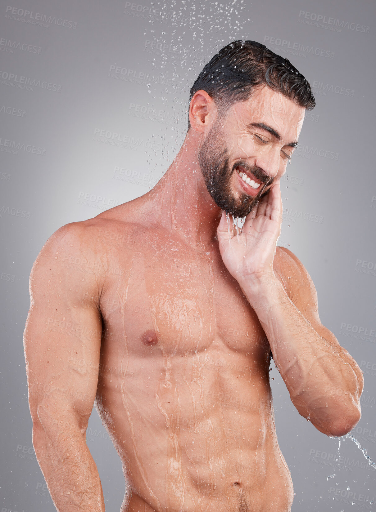 Buy stock photo Shower, water and clean man in a studio for hygiene, grooming and body care for wellness. Self care, washing and handsome male model doing a fresh morning health routine isolated by a gray background