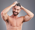 Shower, shampoo and cleaning hair with a man in studio on a gray background for hygiene or grooming. Water, haircare and washing with a happy or handsome young male in the bathroom keratin treatment