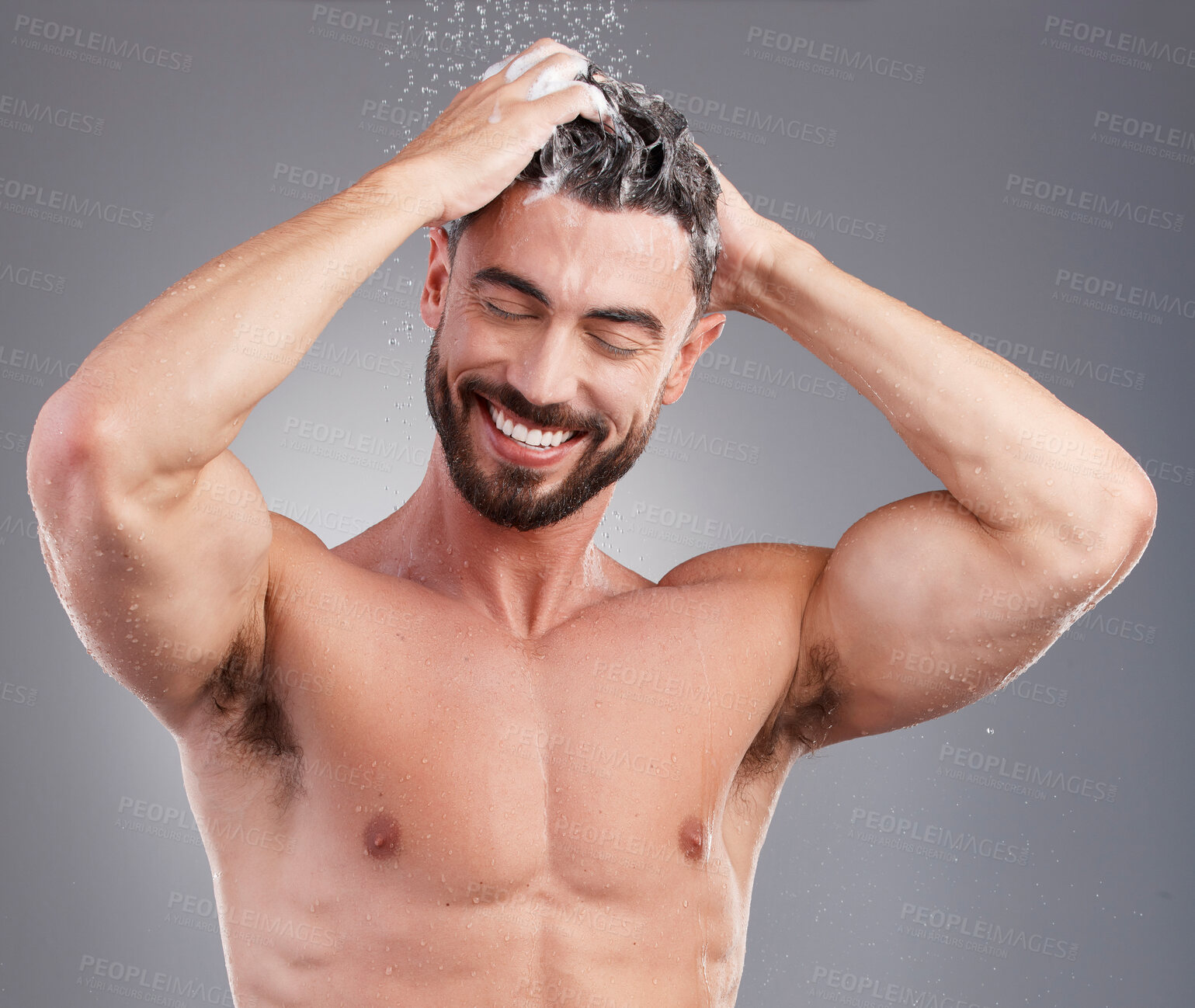 Buy stock photo Shower, shampoo and cleaning hair with a man in studio on a gray background for hygiene or grooming. Water, haircare and washing with a happy or handsome young male in the bathroom keratin treatment