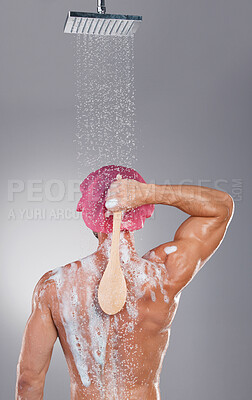 Buy stock photo Back, shower and man cleaning, water splash and hygiene with wellness, skincare and on grey studio background. Muscular male, guy and washing with soap, foam and scrub for body care and backdrop