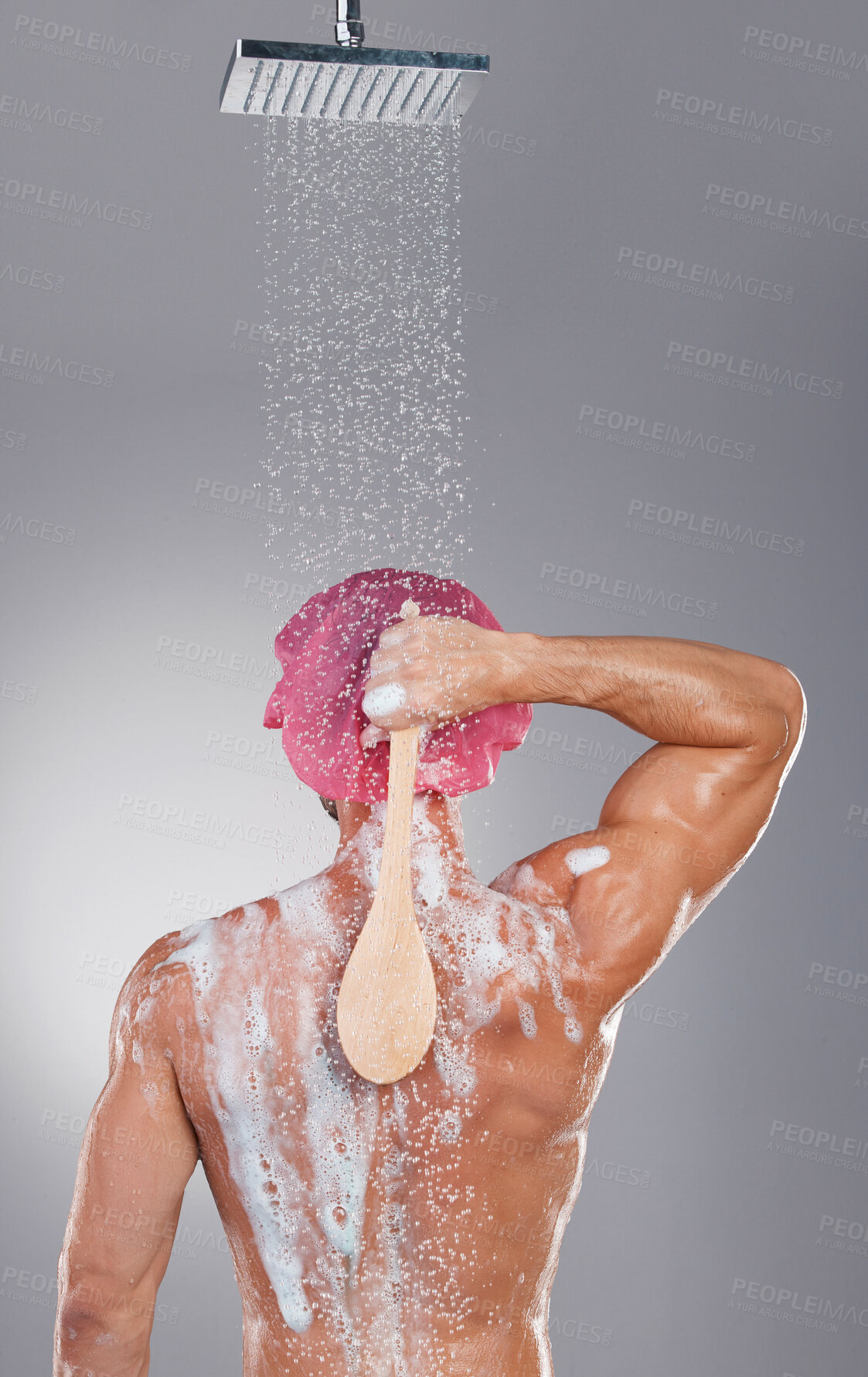 Buy stock photo Back, shower and man cleaning, water splash and hygiene with wellness, skincare and on grey studio background. Muscular male, guy and washing with soap, foam and scrub for body care and backdrop