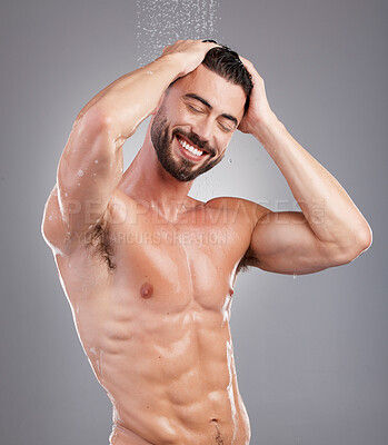 Buy stock photo Bathroom, shampoo and cleaning hair with a man in studio on a gray background for hygiene or grooming. Water, haircare and washing with a handsome young male in the shower for keratin treatment