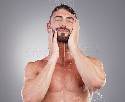 Buy stock photo Cleaning, shower and man with water in studio on gray background for wellness, grooming and beauty. Skincare, bathroom hygiene and male smile for washing body, clean face and soap for healthy skin