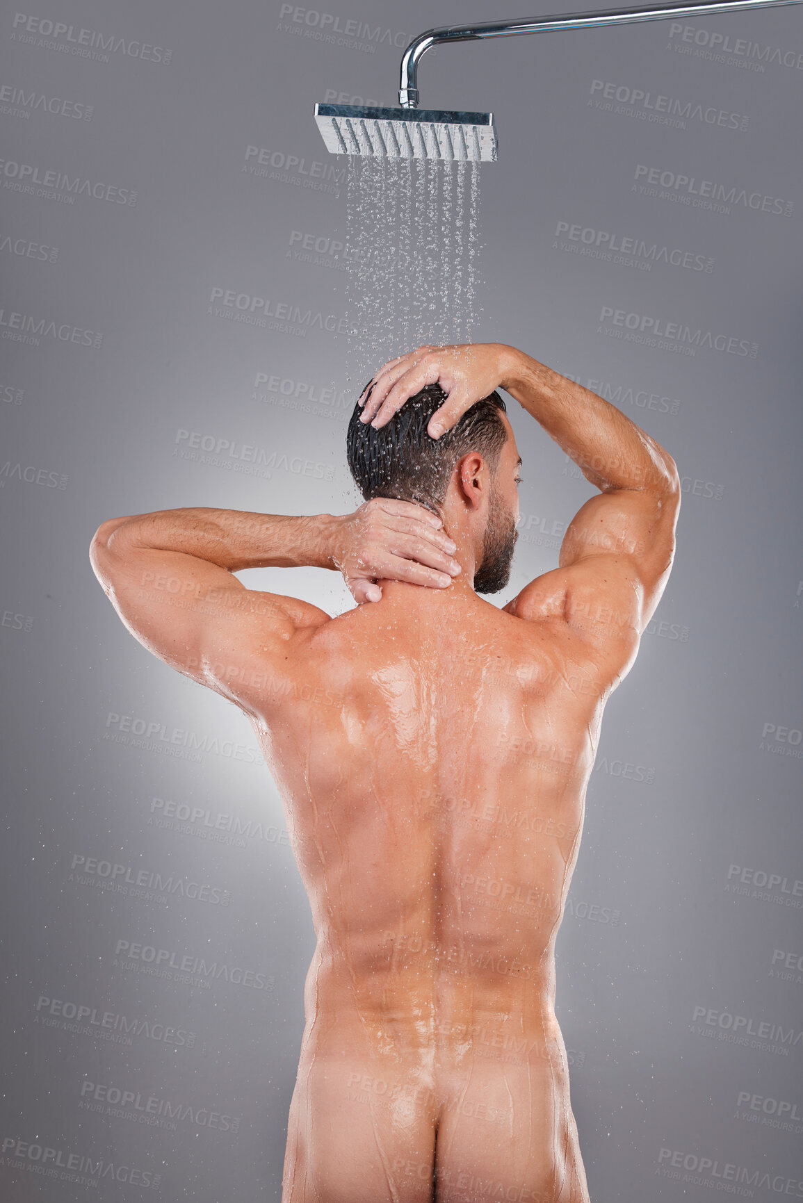 Buy stock photo Naked, routine and back of a man in the shower for health isolated on grey studio background. Morning, grooming and nude body of a person cleaning for shampoo, hygiene and washing with water