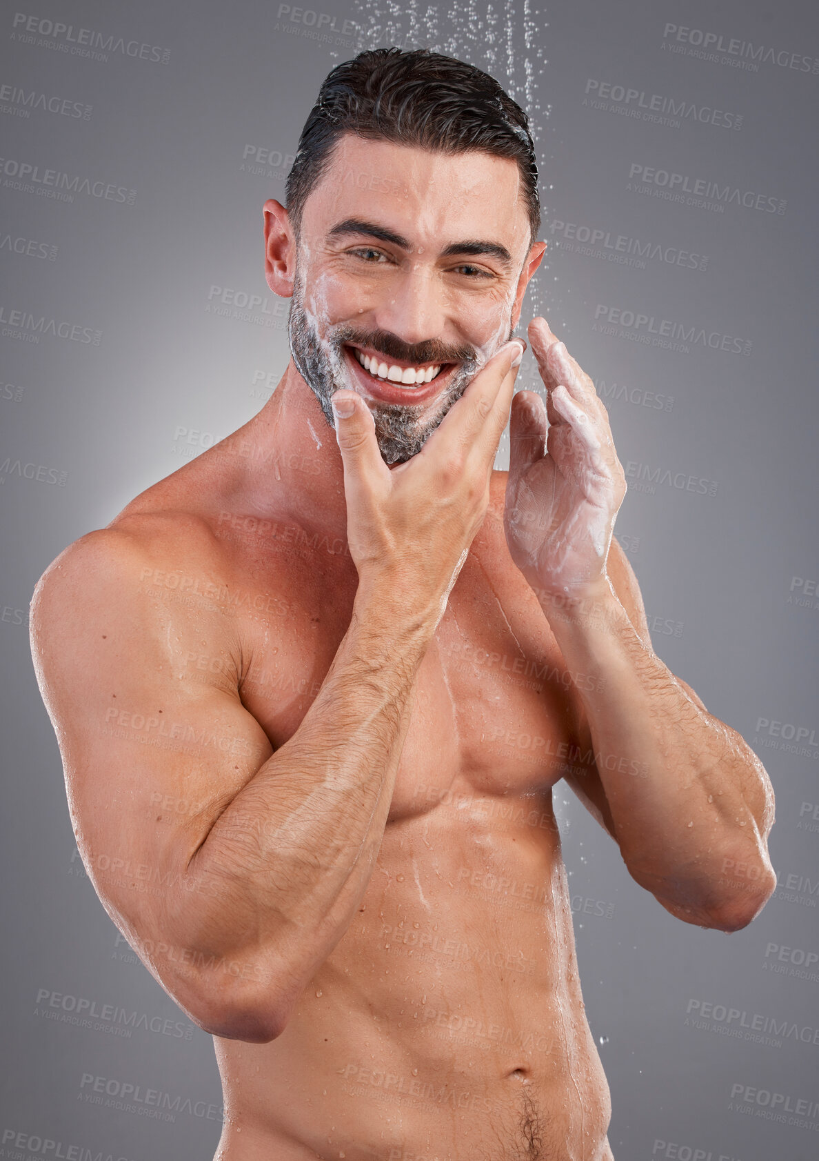 Buy stock photo Shower, water and portrait of man with soap in studio gray background for wellness, grooming and beauty. Skincare, bathroom hygiene and male smile for washing, clean face and beard for healthy skin