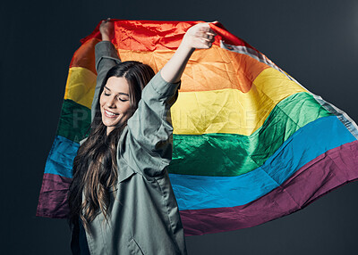 Buy stock photo Flag, pride and happy woman, lgbtq and freedom to love, inclusion and equality, protest for human rights. Gay, trans and lesbian, politics and identity with community and rainbow on studio background