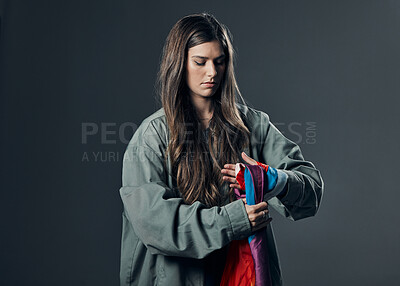 Buy stock photo Protest, LGBTQ and woman with flag in studio wrapping it on hand for human rights and equality. Empowerment, sexuality and female political activist with bisexual material isolated by gray background