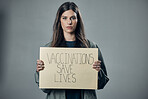 Woman, protest and poster for vaccination, flu shot or health and safety against gray studio background. Portrait of female activist with billboard for healthcare, covid or vaccine message on mockup