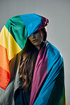 Rainbow flag, pride and woman, lgbtq and freedom to love, inclusion and equality, protest for human rights. Gay, trans and lesbian, politics and identity with community isolated on studio background