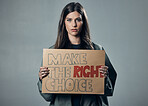 Vaccine, choice and portrait of a woman with a sign isolated on a grey studio background. Decision, showing and girl with a poster for healthcare, medical attention and safety from covid on backdrop