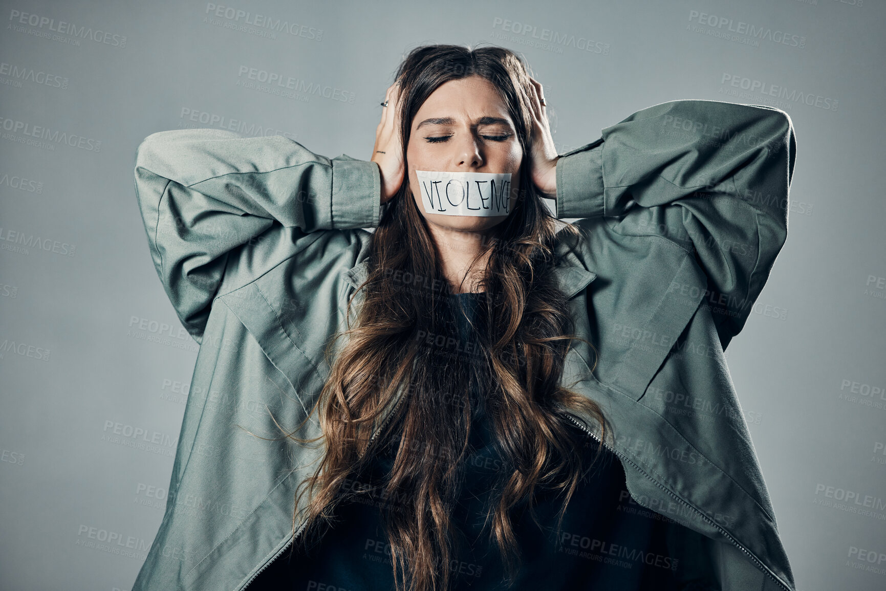 Buy stock photo Woman, protest and tape on mouth in fear for cold war, armageddon or doomsday against gray studio background. Female activist with hands on head and message to stop or end global violence in society