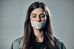 Woman, tape and mouth with silence for protest, social activism and fight against covid 19 by background. Human rights, gen z girl and studio with healthcare opinion for  freedom, choice and vision