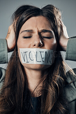 Buy stock photo Woman, protest and tape on mouth in fear for cold war, armageddon or doomsday against a gray studio background. Female activist face with hands on head and message to stop or end global violence