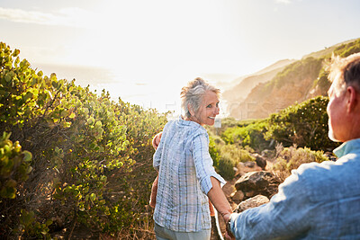 Buy stock photo Love, holding hands and nature, senior couple walking with picnic blanket for romance and valentines day. Green mountain path, old man and woman on walk or hike for romantic valentine date at sunset.