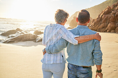 Buy stock photo Beach, love and an old couple walking on the sand by the ocean or sea for romance or dating at sunset. Nature, summer or back with a mature woman and man taking a romantic walk together on the coast
