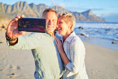 Buy stock photo Selfie, love and senior couple with a phone at the beach for a vacation memory in Portugal. Video call, communication and hand of an elderly man with a mobile for a photo with a woman at the sea