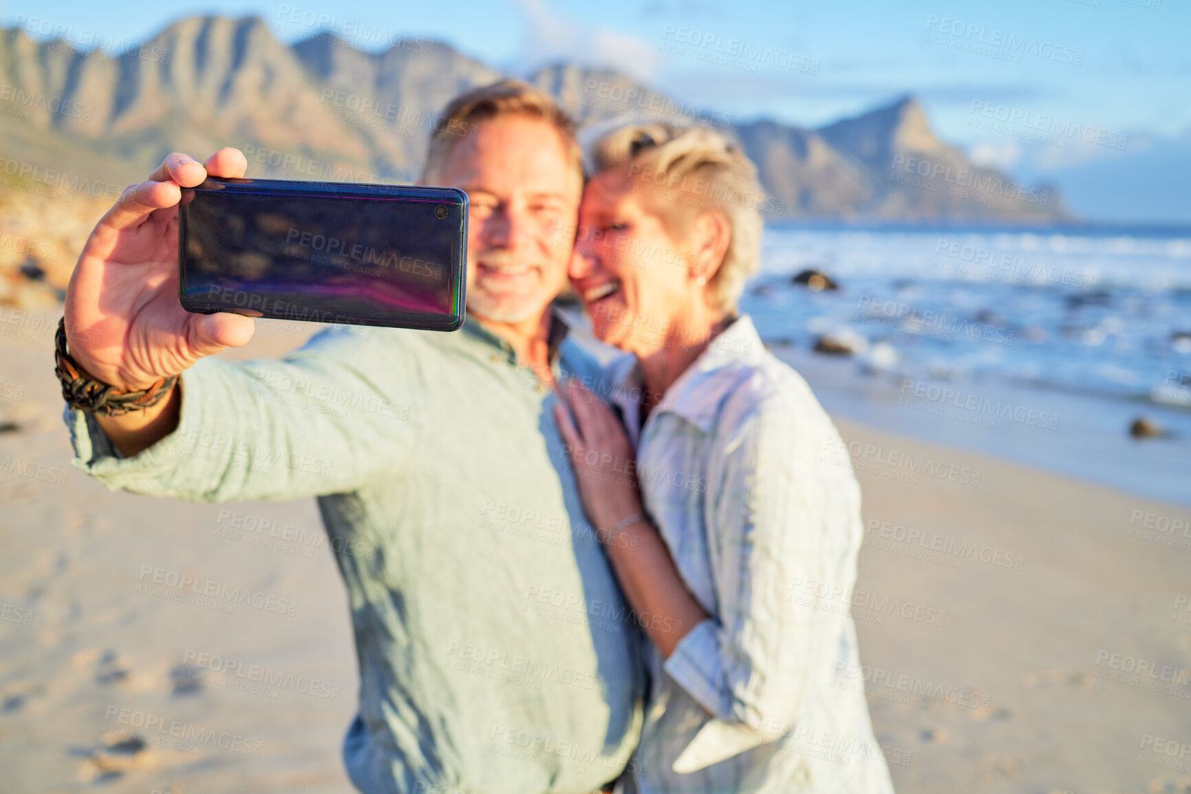 Buy stock photo Selfie, love and senior couple with a phone at the beach for a vacation memory in Portugal. Video call, communication and hand of an elderly man with a mobile for a photo with a woman at the sea