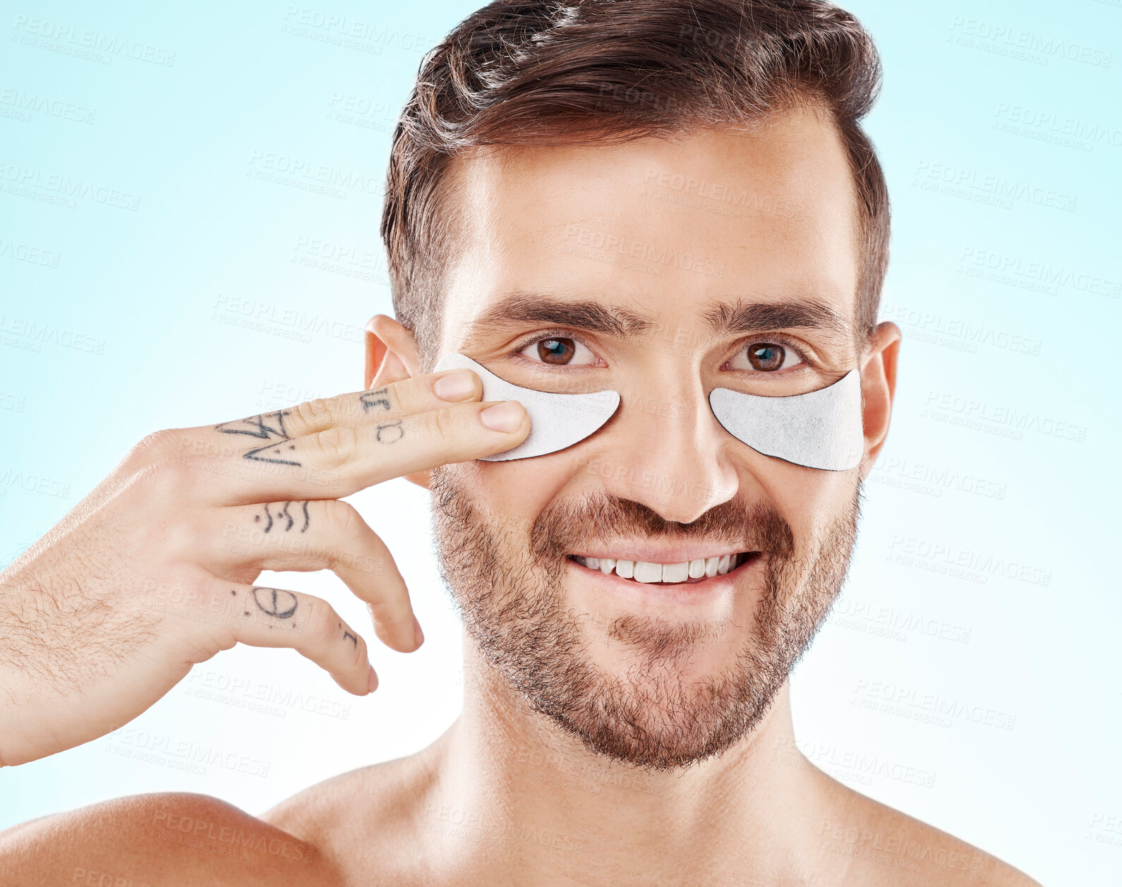 Buy stock photo Face, skincare and man with eye patches in studio isolated on a blue background. Beauty, portrait and male model with  pad product for dermatology, cosmetics and facial treatment, wellness and health