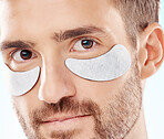 Eye beauty, man portrait and treatment patches for eyes in a isolated studio with white background. Skincare, spa wellness and facial for model face with cosmetics, dermatology and detox with mask