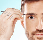 Beauty, eyebrows and hair removal with man  and tweezers for grooming, hygiene and wellness. Cosmetology, treatment and facial growth with model and tool for morning routine, trimming and cleaning