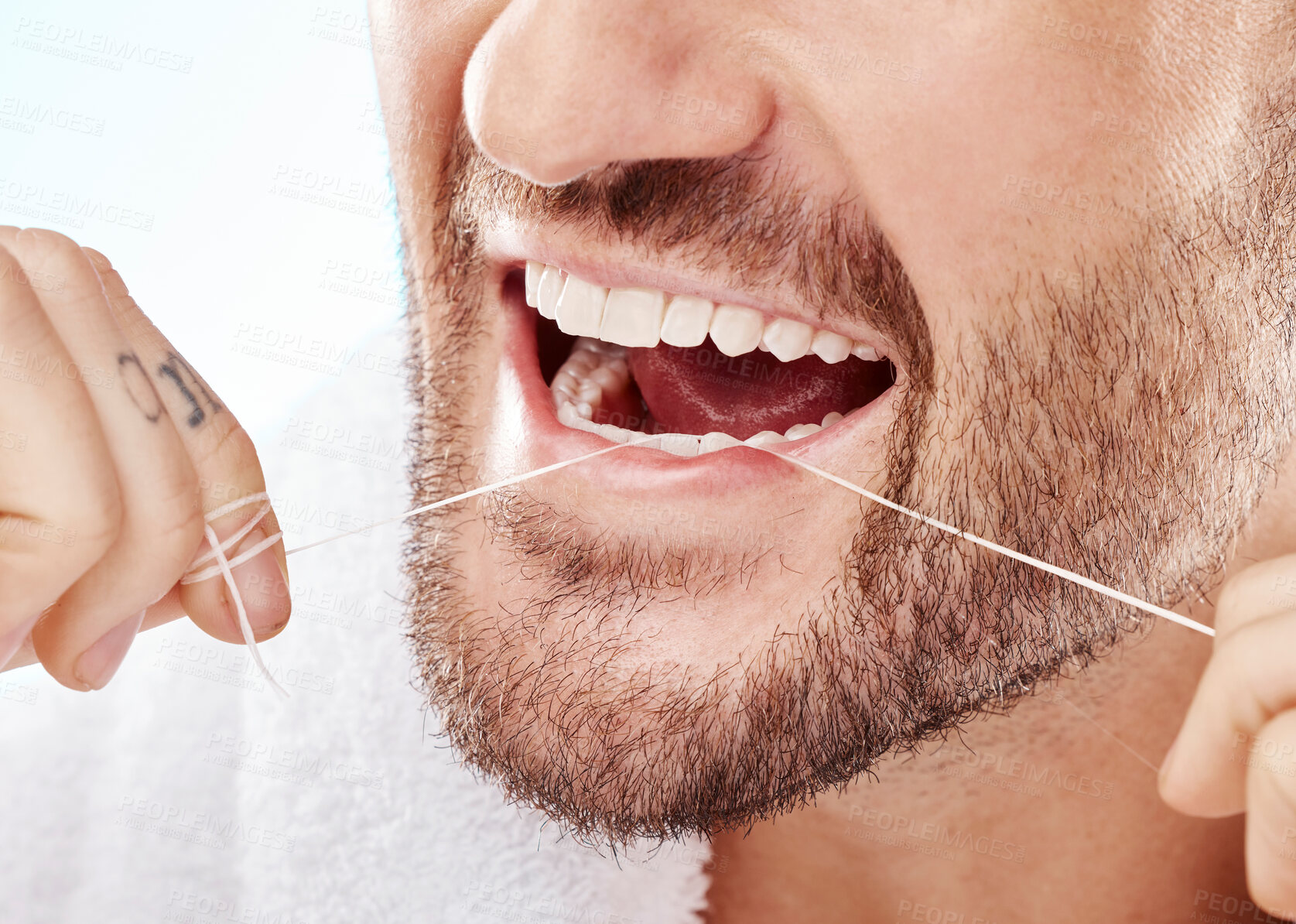 Buy stock photo Dental, hygiene and man flossing his teeth in a studio for oral care, grooming or health. Wellness, healthy and closeup of male model doing fresh, clean and natural mouth routine by white background.