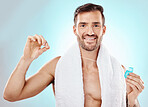 Portrait, floss and man with oral health, smile and wellness against blue studio background. Face, male and gentleman with string for dental hygiene, clean teeth and thread for hygiene and grooming 