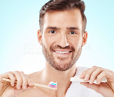 Buy stock photo Smile, portrait or happy man brushing teeth with dental toothpaste for healthy oral hygiene grooming in studio. Eco friendly, smile or male model cleaning mouth with a natural bamboo wood toothbrush 