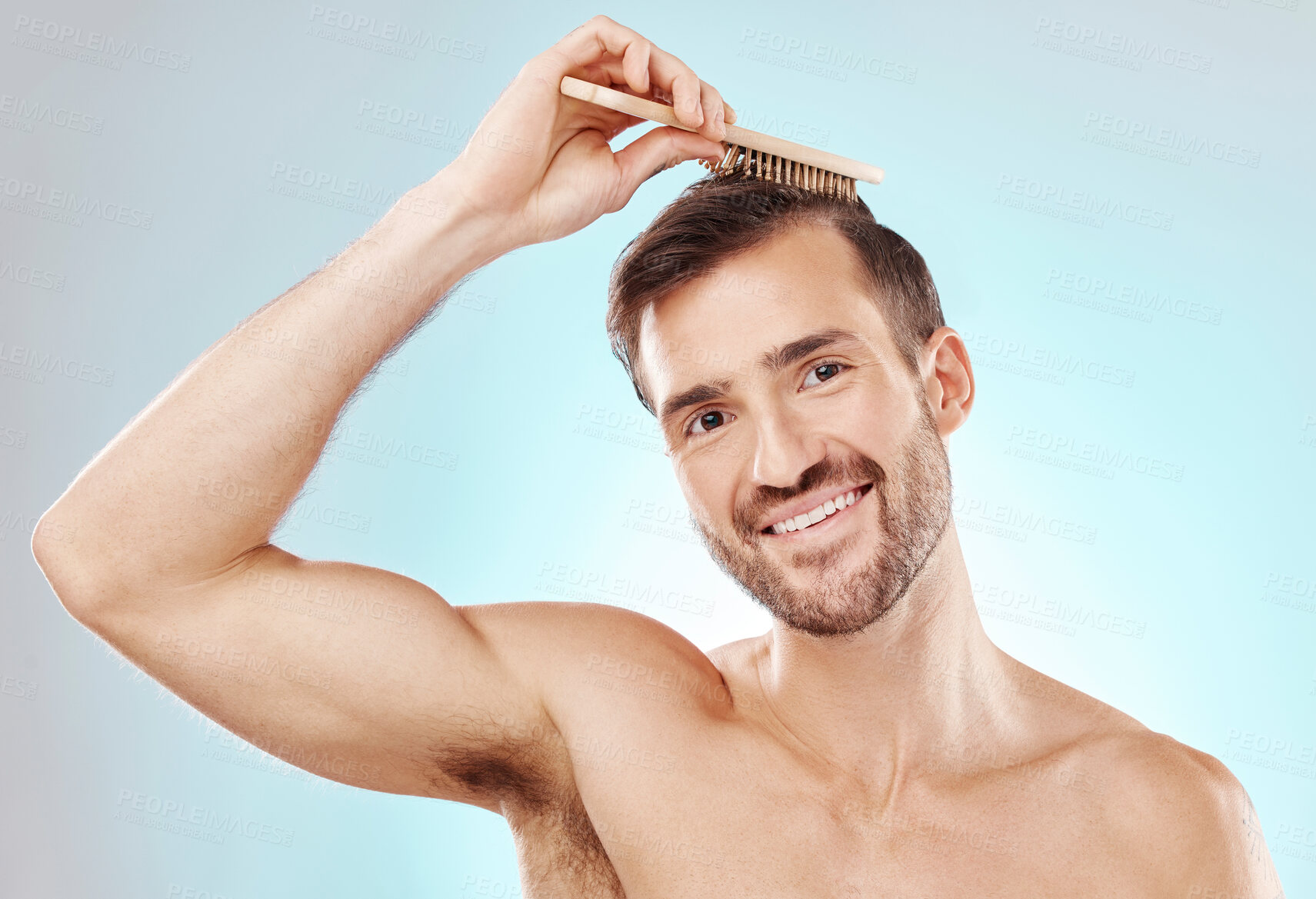 Buy stock photo Hair, man in portrait and beauty with brush and grooming with hygiene on blue background. Cosmetic care, clean and fresh with hairstyle, wellness and routine with skin, glow and towel for haircare