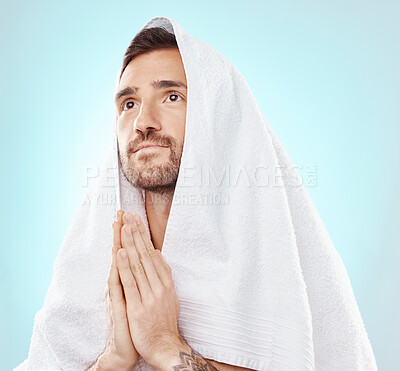 Prayer, thinking and worship with man and towel for hope, spiritual and Catholic faith. Respect, religion and Holy spirit with guy and hands for believer, humble and Christianity with blue background