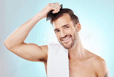 Buy stock photo Hair care, man in portrait and beauty with comb and grooming with hygiene on blue background. Cosmetics, clean and fresh with hairstyle, wellness and routine with skin, glow and towel with skincare