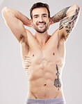 Tattoo, fitness and sexy with portrait of man for sports, health and gym bodybuilder. Happy, smile and wellness with model and muscle body for nutrition, training and beauty with studio background 