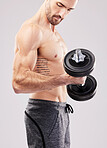 Arm training, dumbbell and bodybuilder man workout in a studio for fitness, exercise and power. Gray background, isolated and gym model weightlifting, bodybuilding focus and doing body wellness