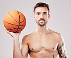 Portrait, basketball and man with fitness, sport and exercise with motivation on grey studio background. Face, male athlete and player with training, workout or practice for tournament or competition