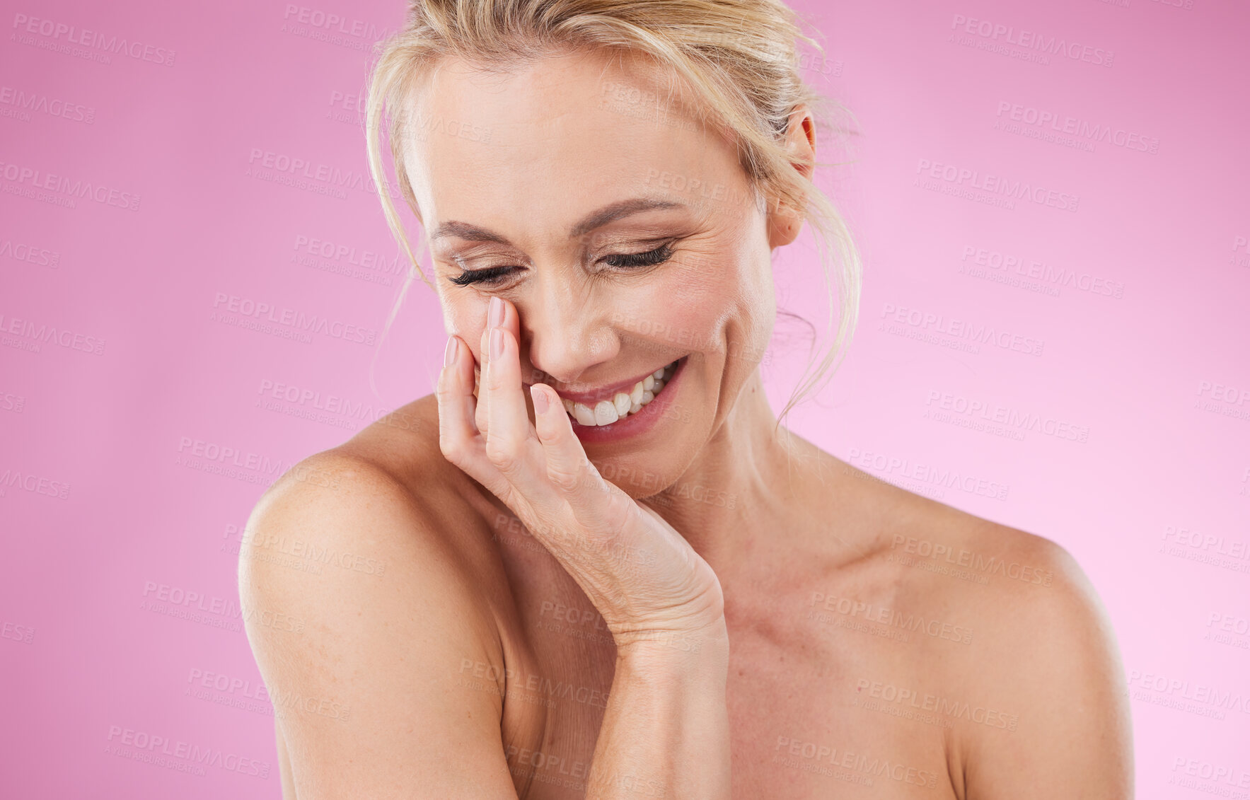 Buy stock photo Laughing, mature and a woman with a skincare glow isolated on a pink background in studio. Smile, thinking and funny cosmetics model with makeup, confidence and beauty treatment on a backdrop